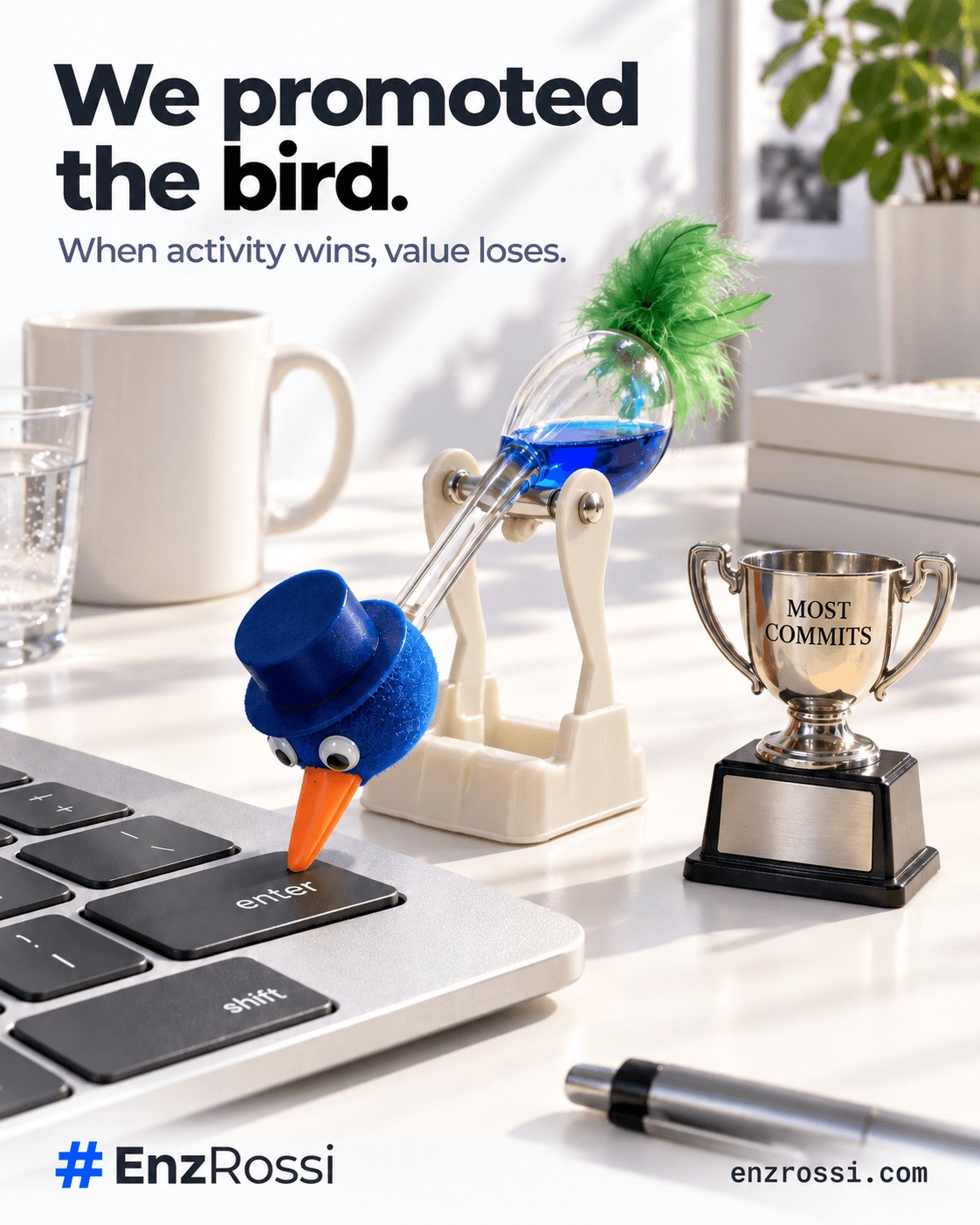 A drinking-bird desk toy presses the Enter key beside a trophy engraved MOST COMMITS. Headline: We promoted the bird. Tagline: When activity wins, value loses.