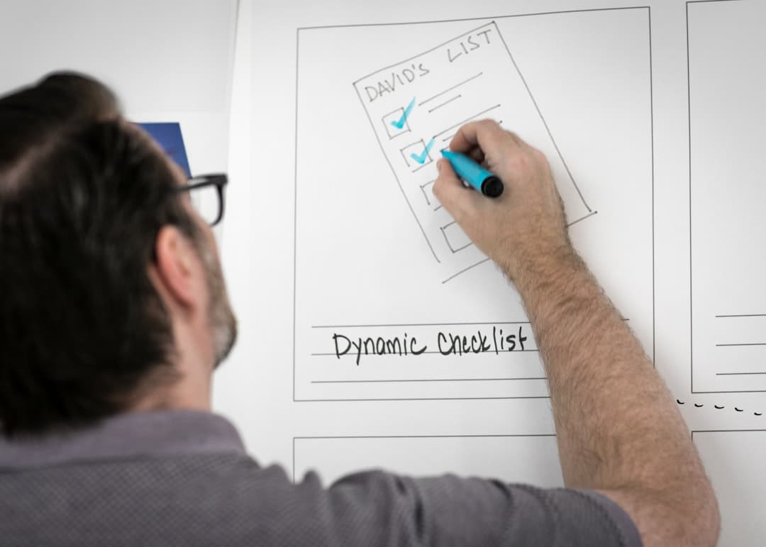 Person writing evaluation notes on a whiteboard