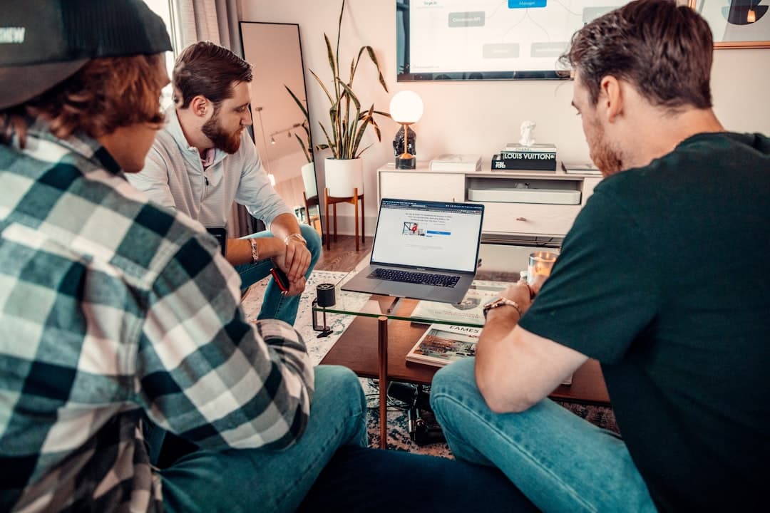 Team gathered around a laptop during onboarding