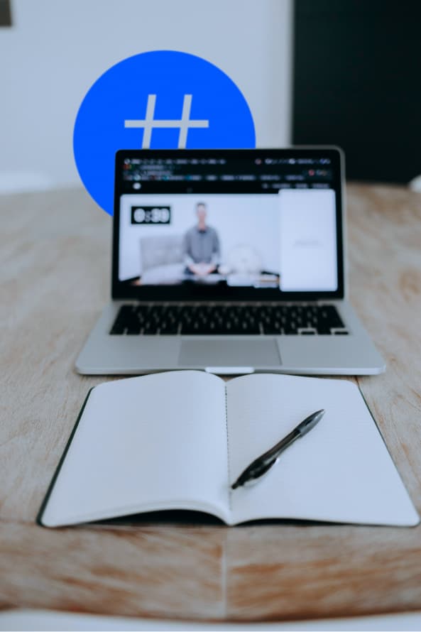 Person learning online with a laptop and notebook