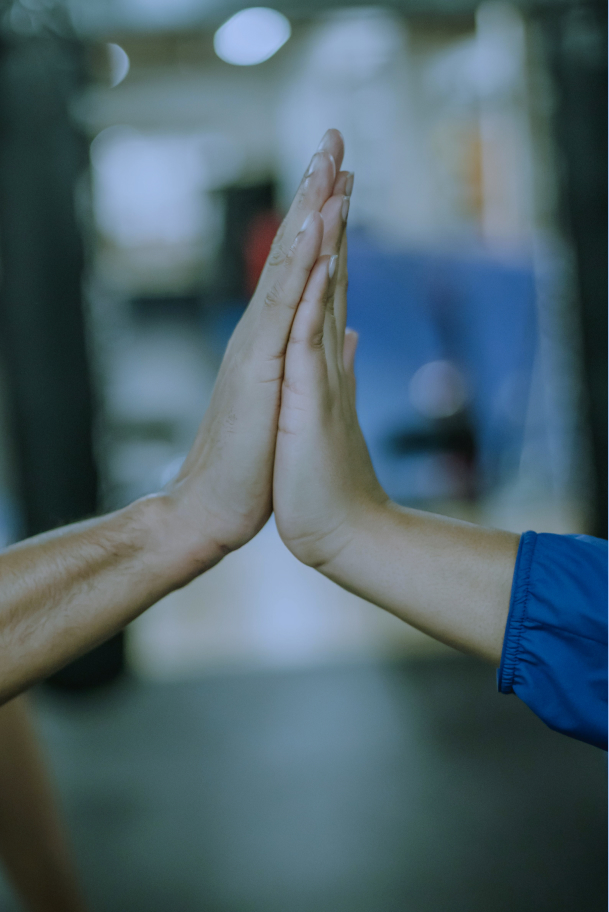 Two people's hands are high-fiving